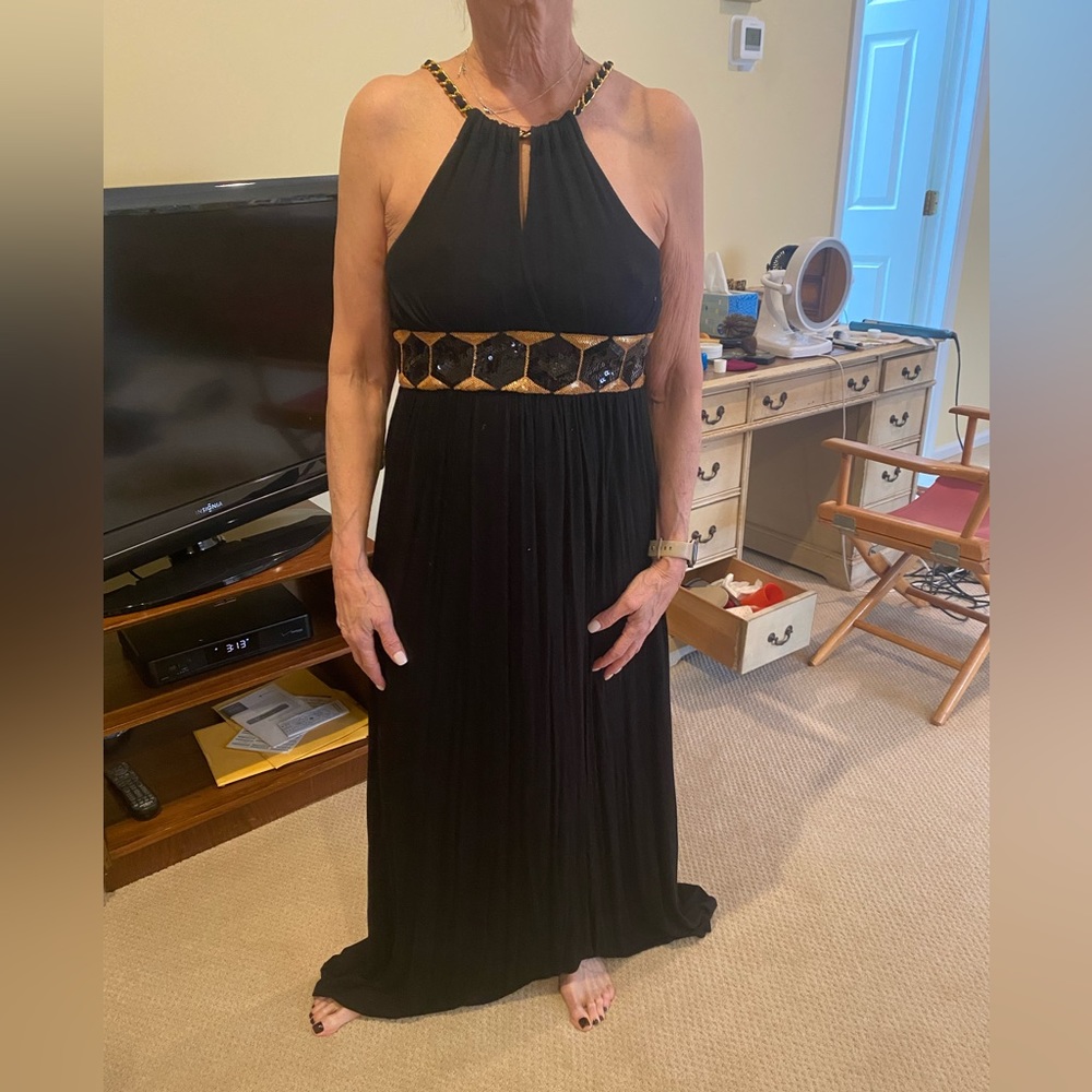 Black gown with gold chain strap and gold and back sequin detail